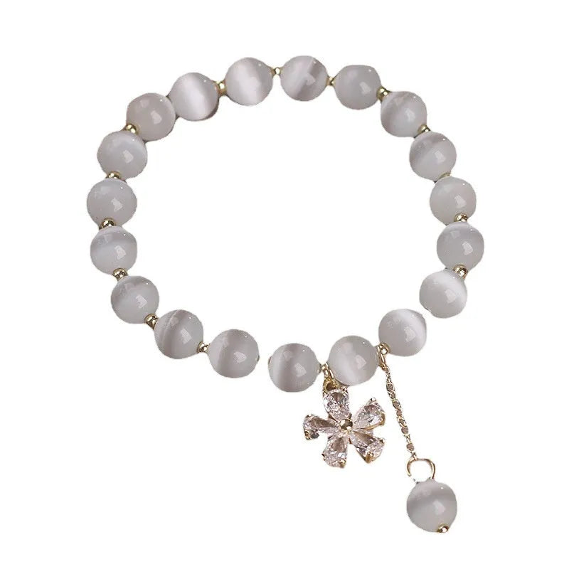 Women's white cat's eye crystal bracelet with flower tassel and morganite safety buckle pendant