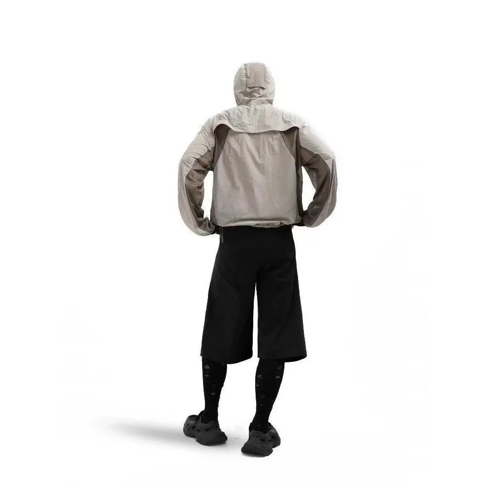 Mesh fabric sun protective clothing in desert brown colour, shown in a regular length fit.