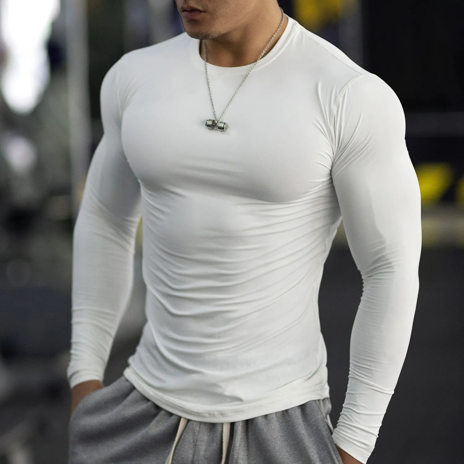 Men's black slim fit fitness tights with long sleeves for running and gym workouts.