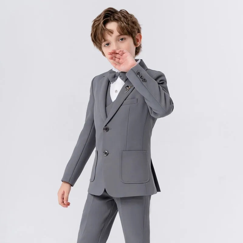 Boys British solid colour suit dress set with single-breasted jacket, long sleeves, vest, bow tie, and brooch in beige blue or gray