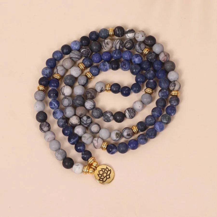 Blue multi-layer bracelet with patterned network stone beads on an alloy chain.