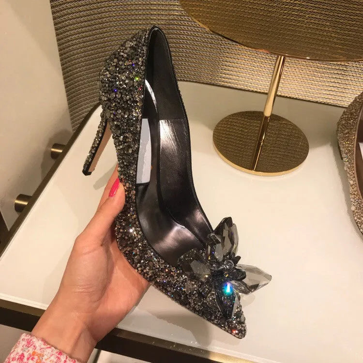 Women's gold pointed toe stiletto high heels with sequin cloth and rhinestone decoration.