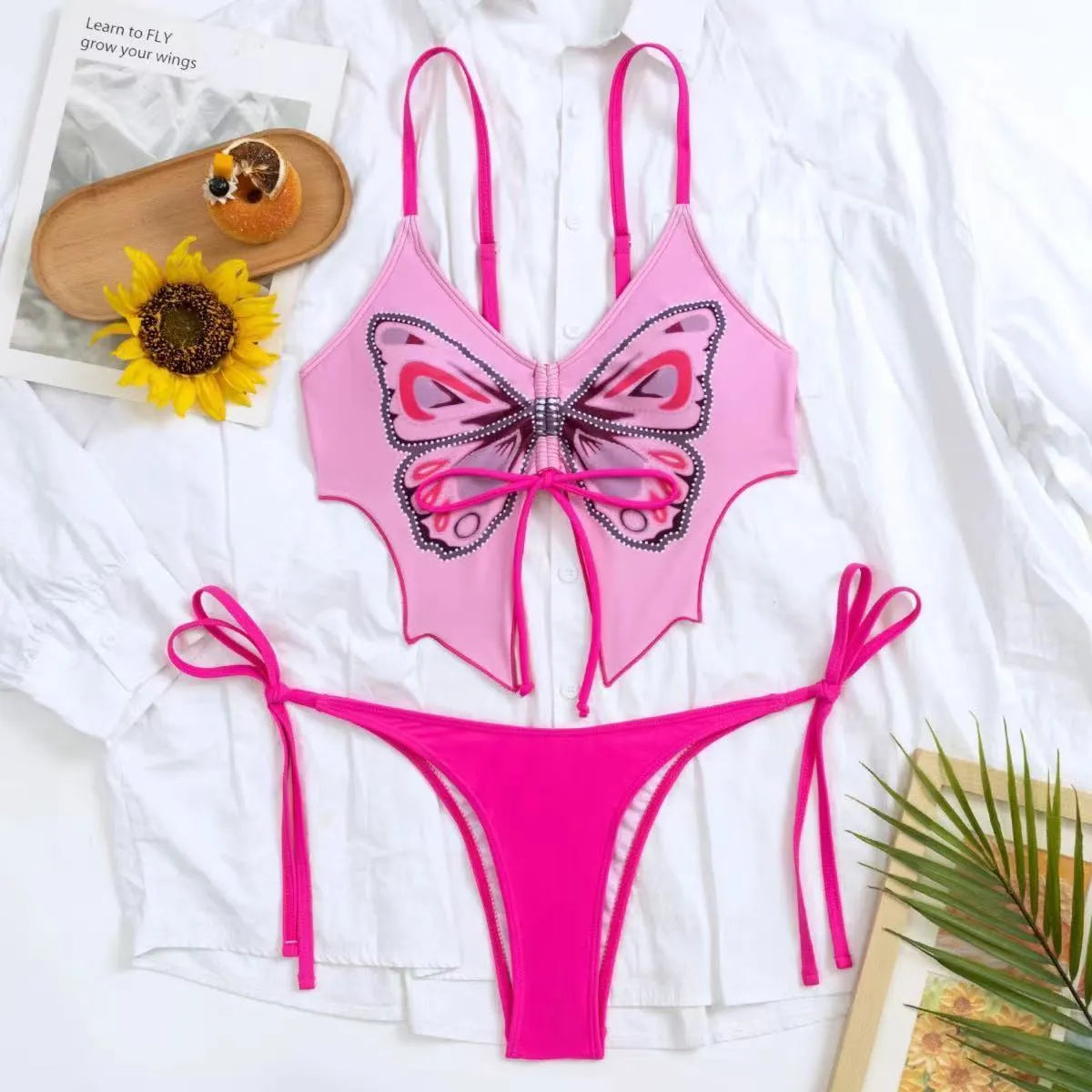 Women's purple bikini suit with bow ins style detail on a split design, made from polyester fabric.