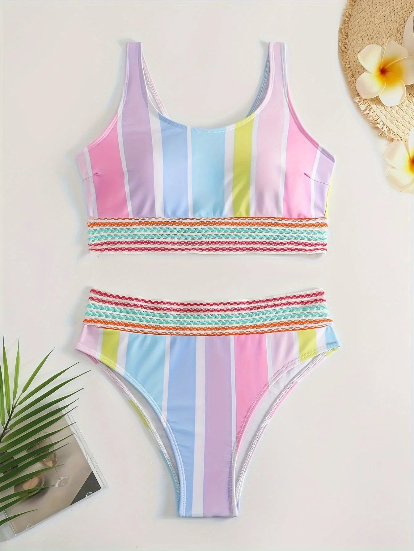 Women's striped two-piece bikini set for swimming and sports on a neutral background.