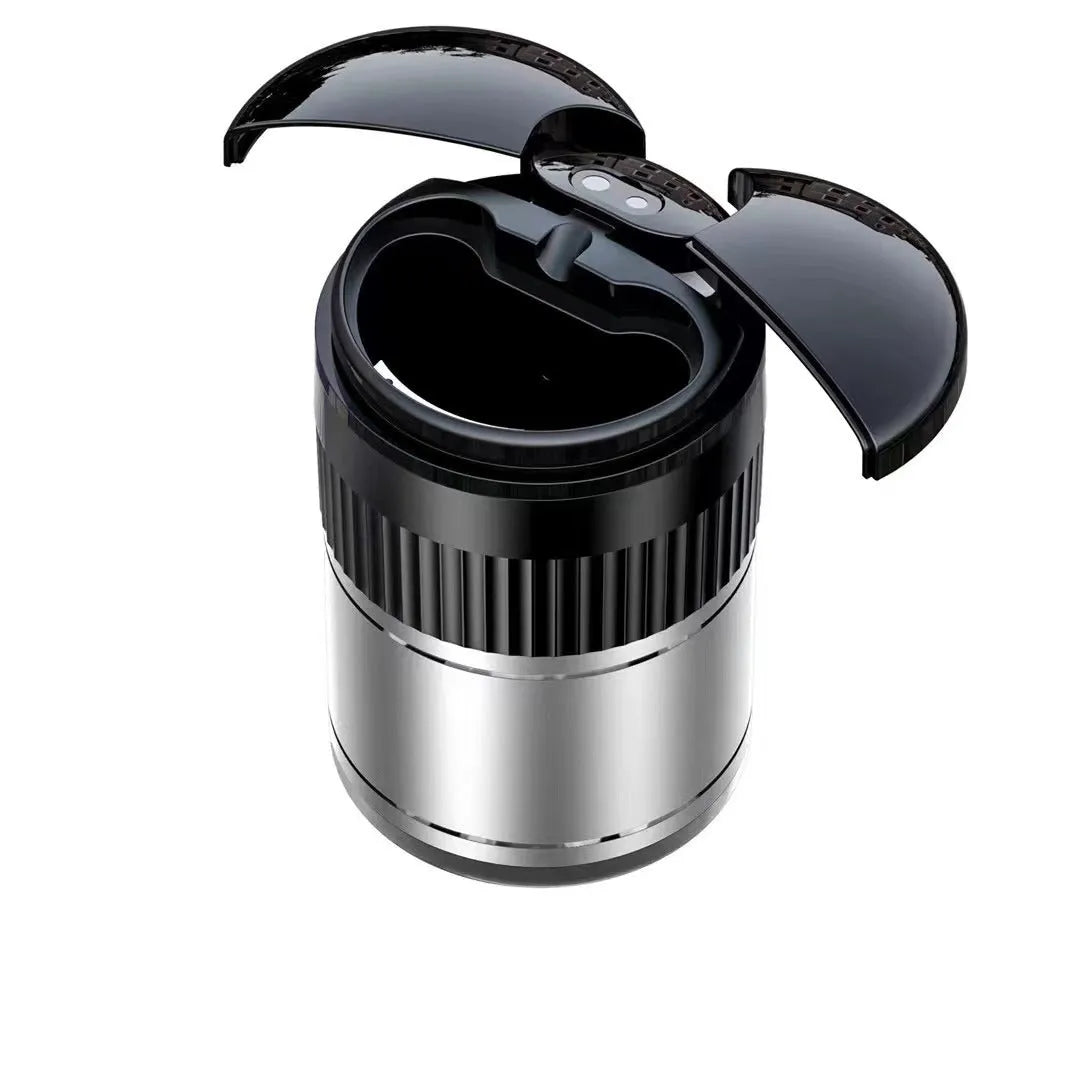 Compact metal car ashtray with lid in black, showing automatic sensor or touch controls.