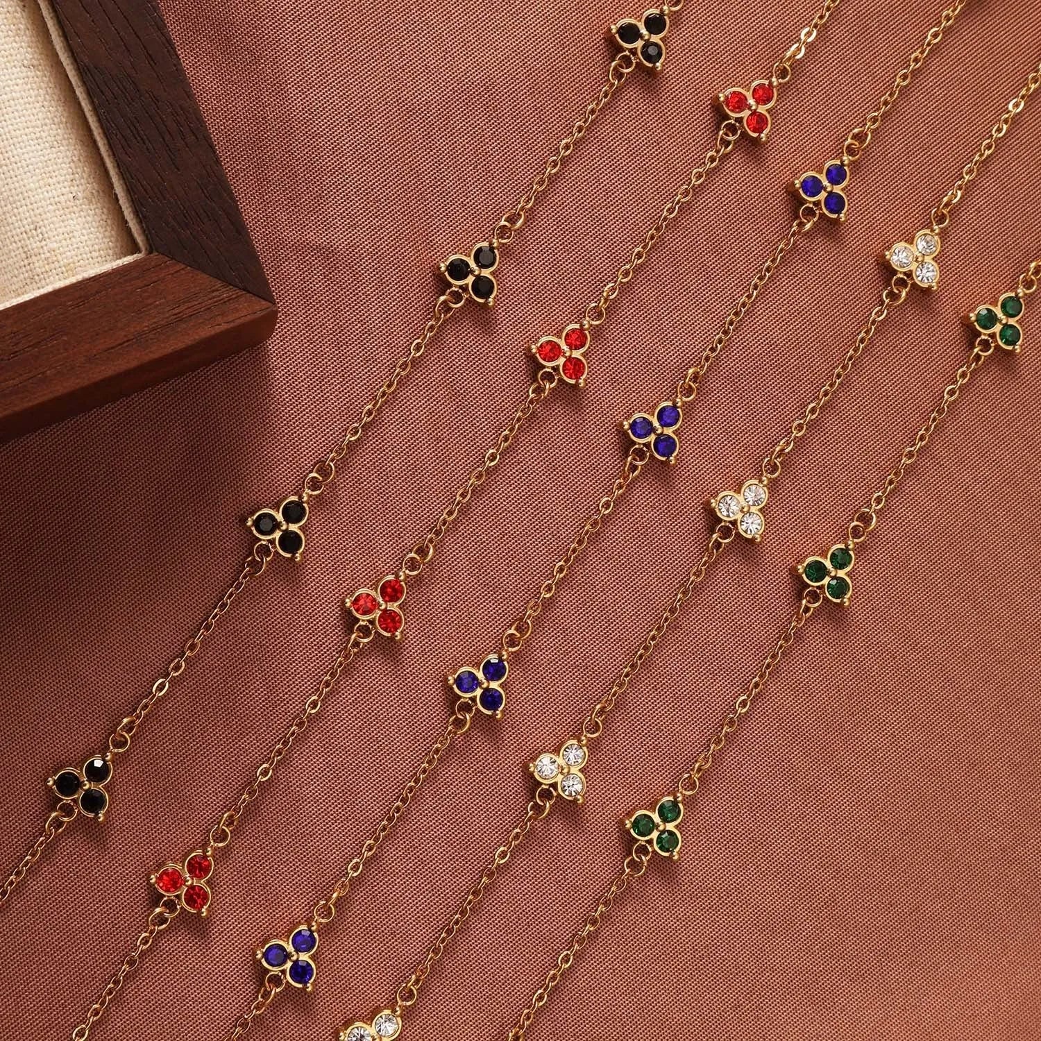 Geometric triangular stainless steel women's bracelet with coloured zircon stones in gold or steel finish.