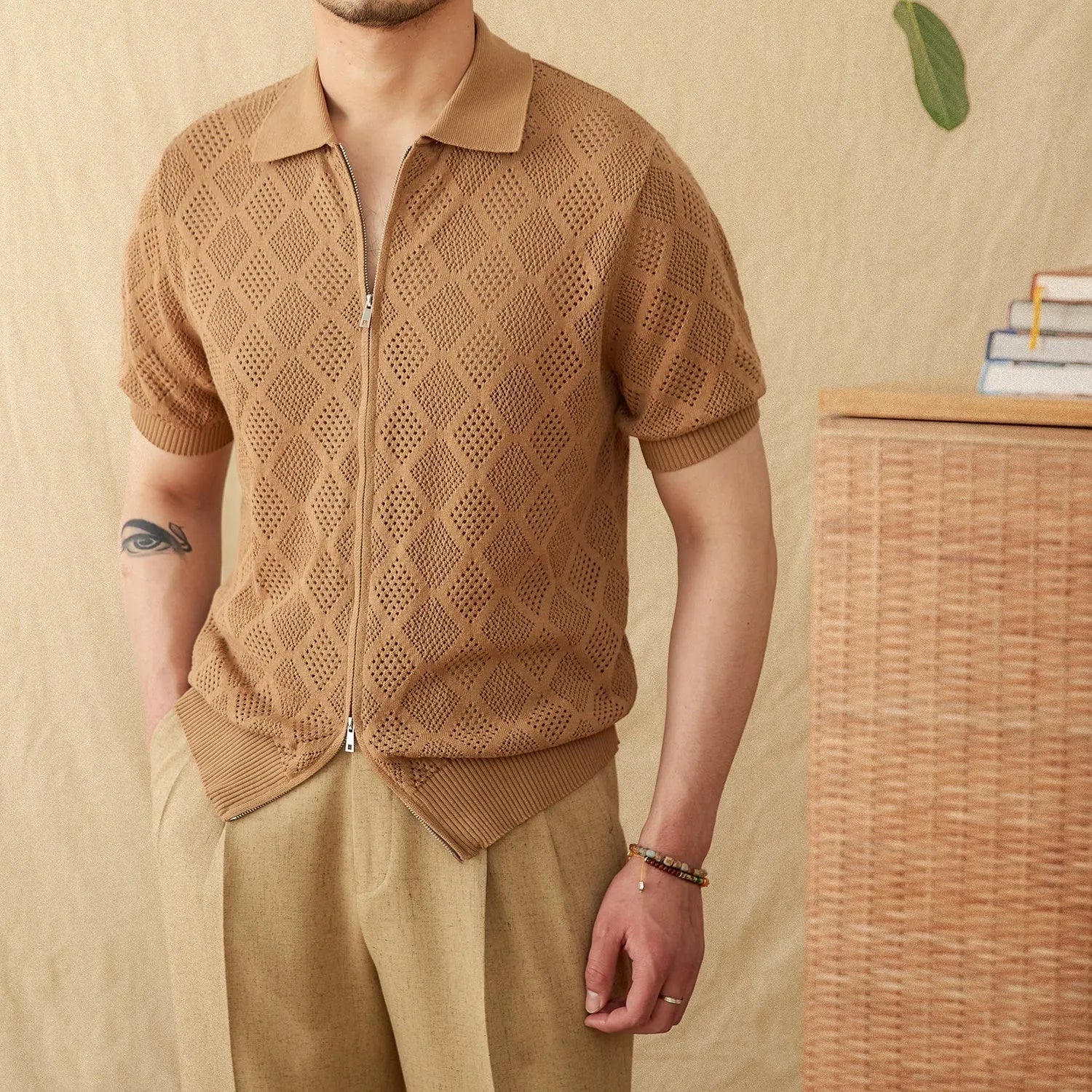 Light brown men's cotton cardigan with zipper front and lapel collar on a hanger.