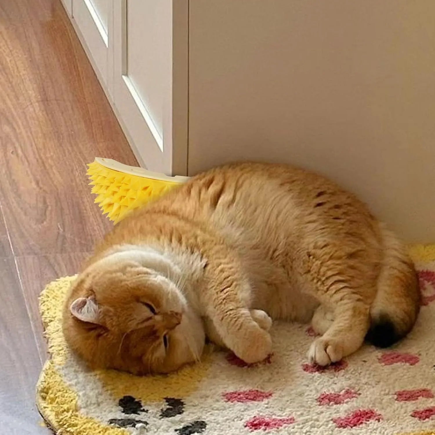 Yellow durian shaped cat corner scratcher mounted on a wall with adhesive backing