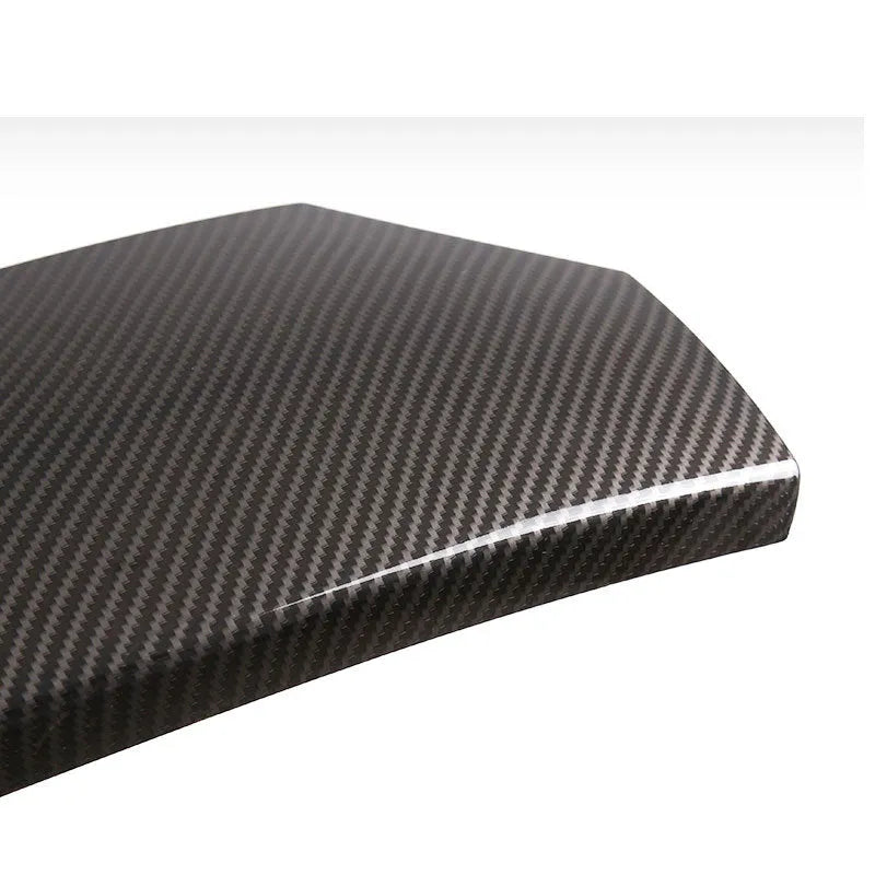 Three black ABS protective covers with a diagonal carbon fibre pattern for a car armrest box