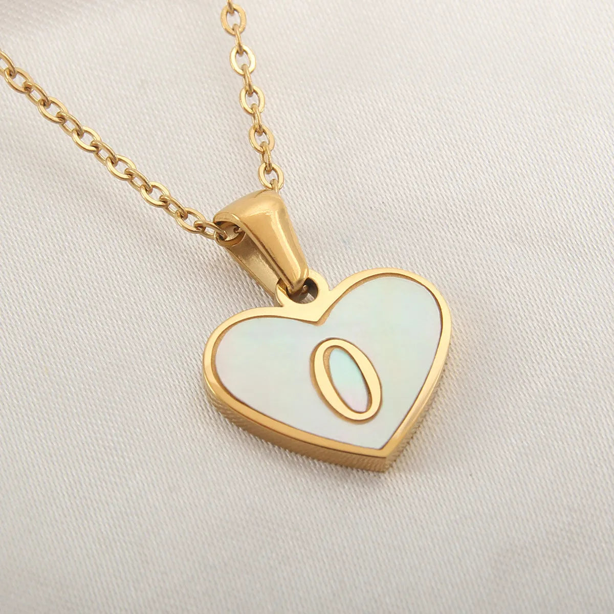 Gold heart necklace with white shell pendant and initial charm on 45cm adjustable chain