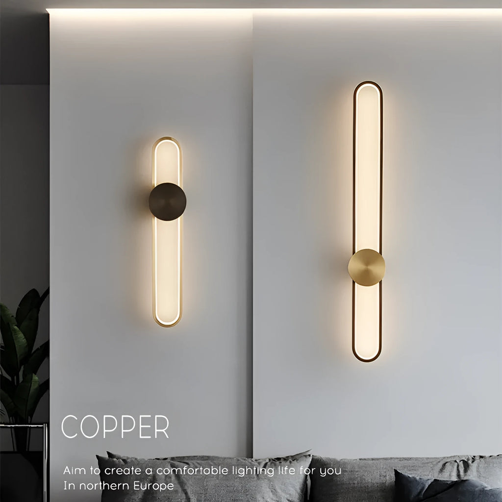 Round modern minimalist wall lamp with iron shade in black or gold finish.
