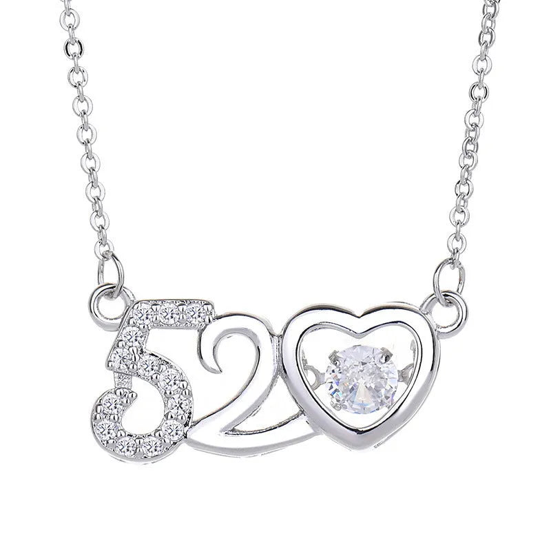 Sterling silver heart necklace with crown and bow decorations in silver and rose gold finishes