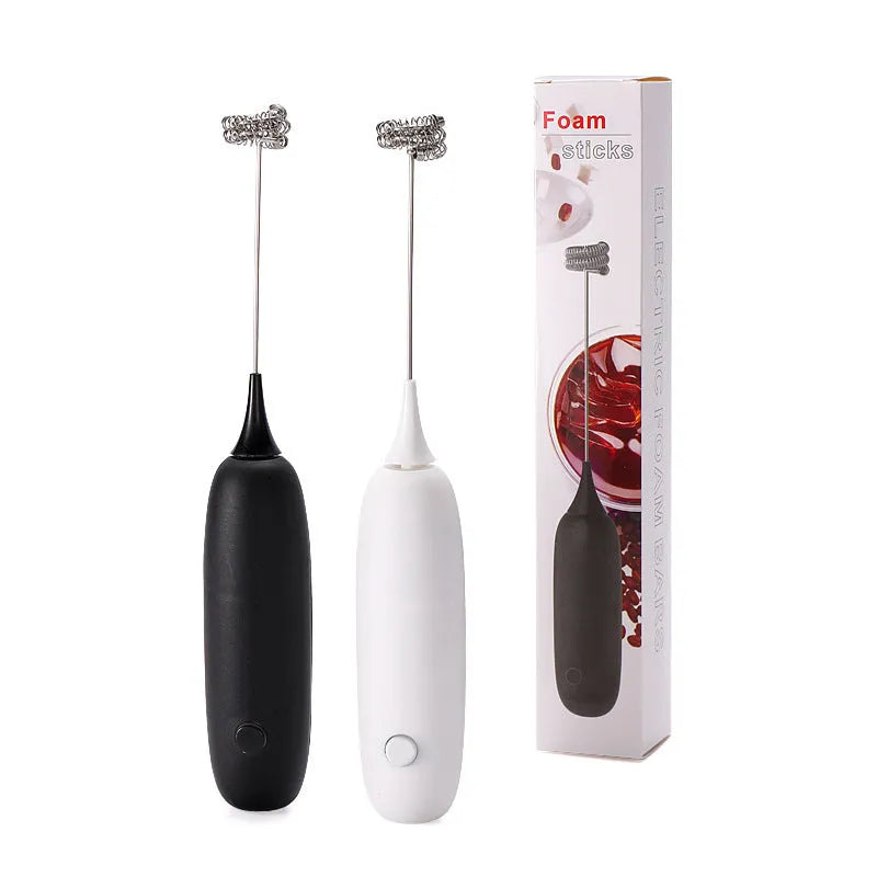Black and white handheld electric milk frother with blending function on kitchen counter