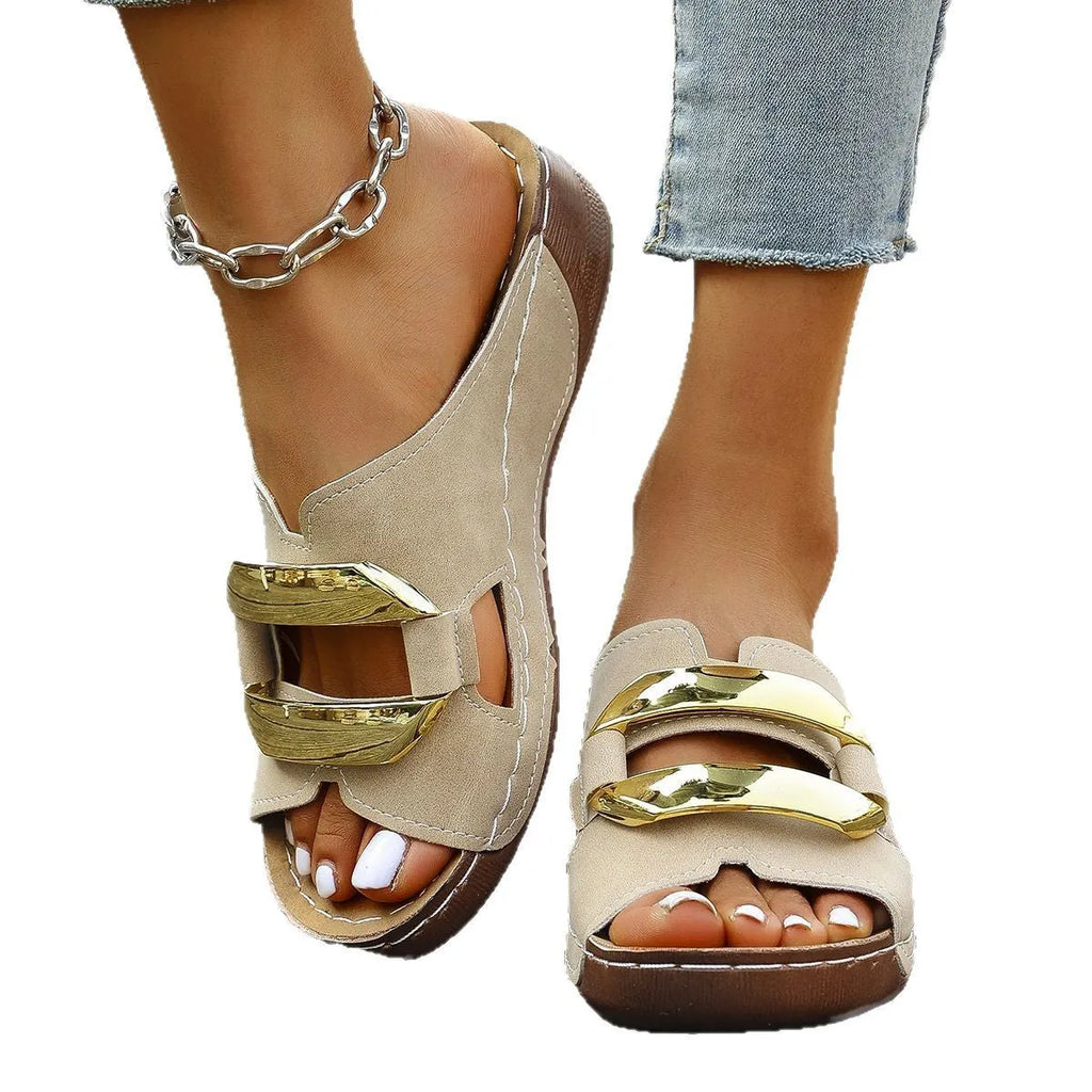 Roman-style platform flip-flop sandals in white, showing flat heel and metal detail.