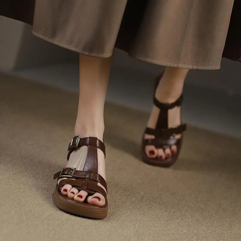 Women's black retro sandals with a T-shaped buckle, open square toe, platform, and chunky heel.
