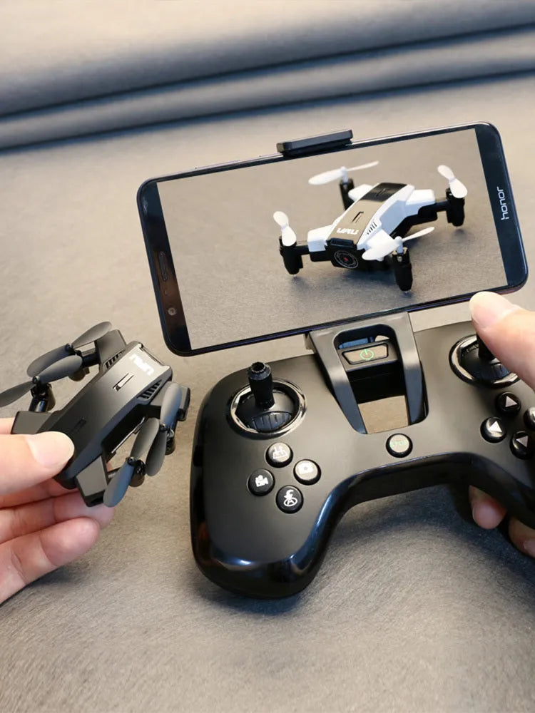 Quadcopter drone with HD 2 million pixel camera, black colour, propellers, and VR glasses on a white background