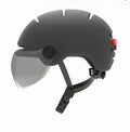 Cycling helmet with built-in rear LED brake light, shown in two sizes M and L