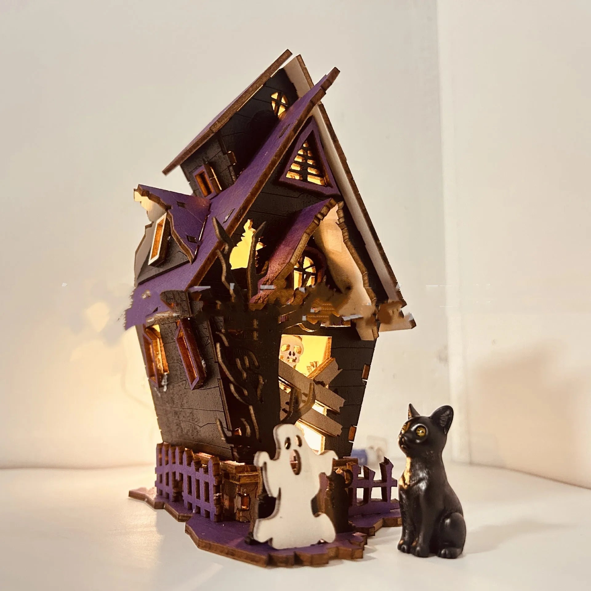 Wooden haunted house decoration with candlestick functionality measuring 14x10.5x19cm for Halloween table displays