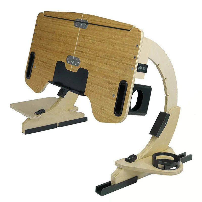 Wooden folding computer table on bed showing adjustable angle feature