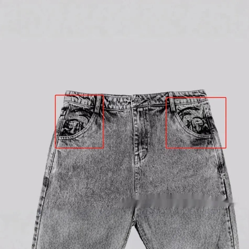 Grey loose straight-leg denim trousers on hanger showing mid-waist design and cotton fabric texture