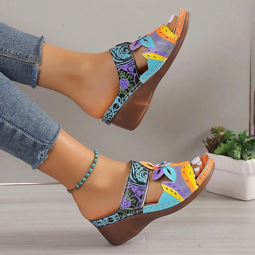 Ethnic patterned slippers in purple with a round toe, cowhide upper, and rubber sole.