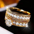 Two geometric gold electroplated zinc alloy rings on a flat surface
