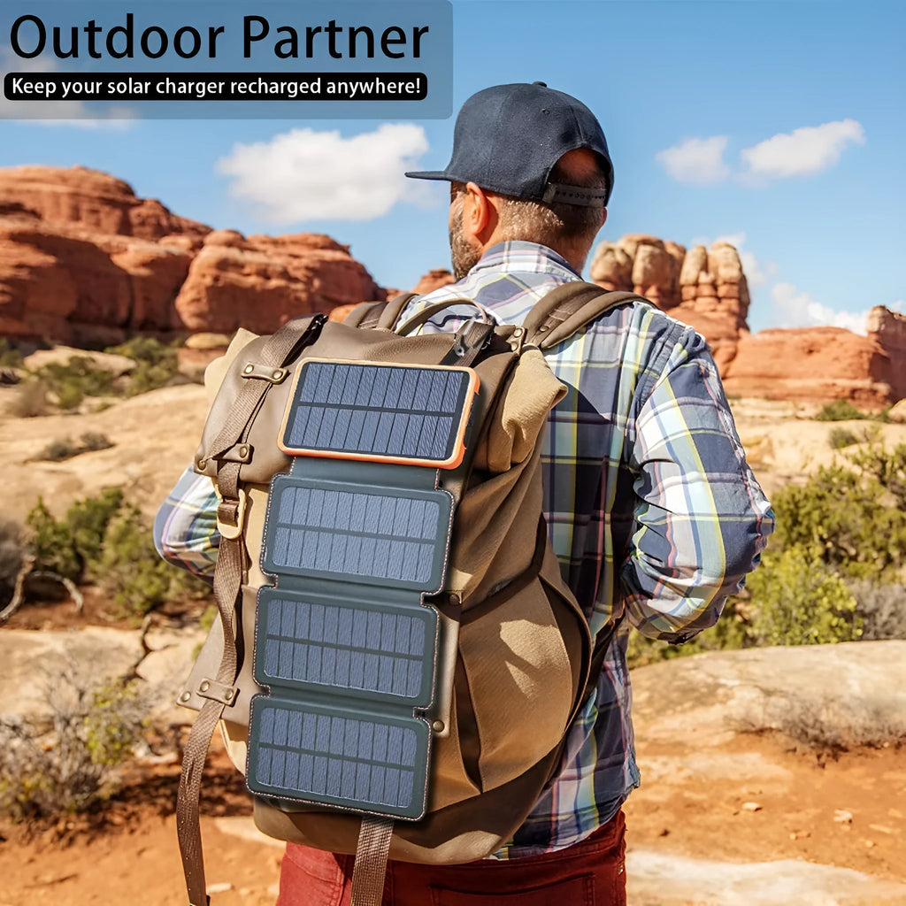 Black solar power bank with a solar panel, LED light, and soft leather exterior, shown outdoors.