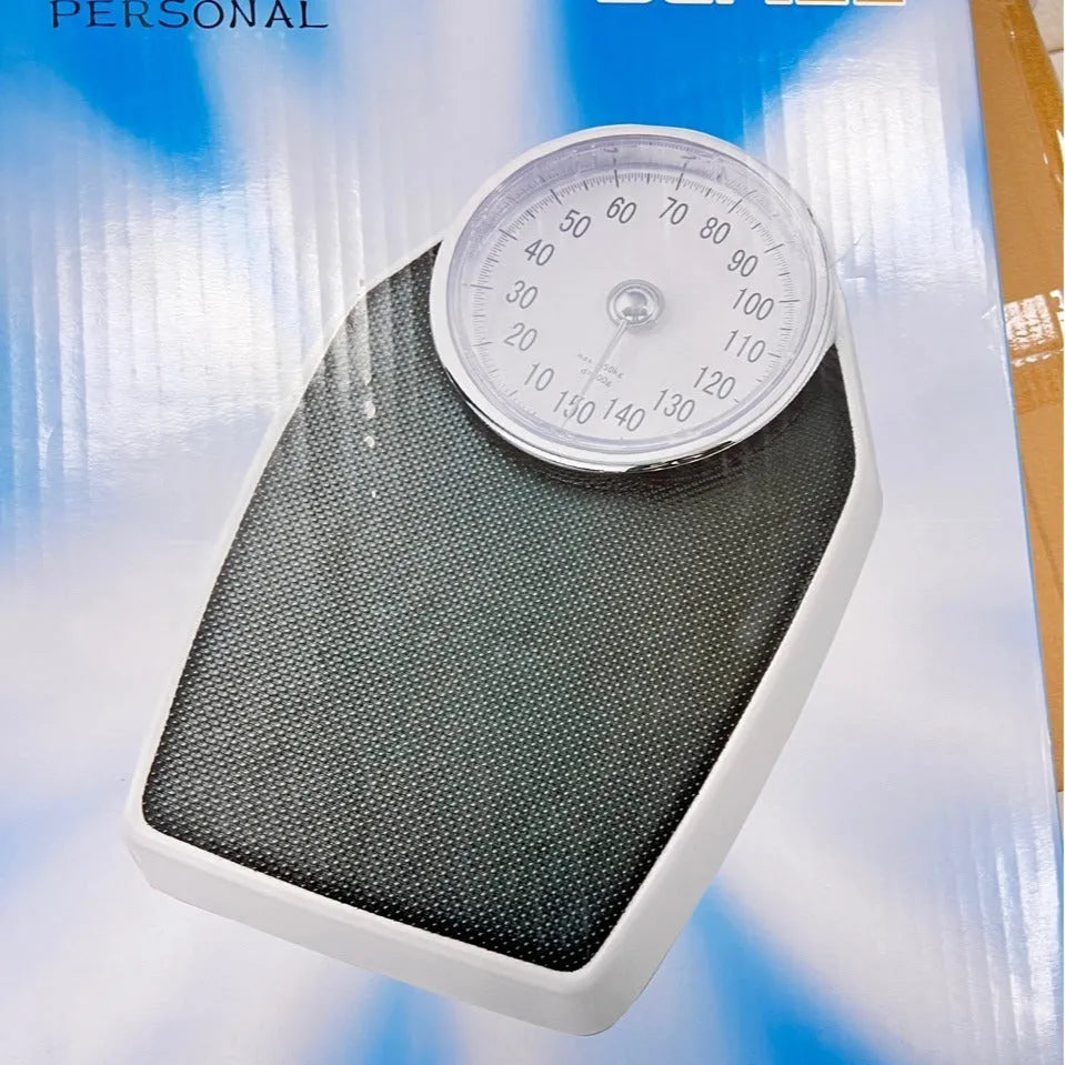 Black mechanical body weight scale with large dial on a simple platform
