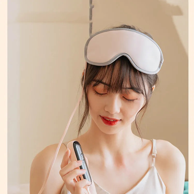 Green portable eye SPA mask with suede shell on a table, showing USB port and steam vents.