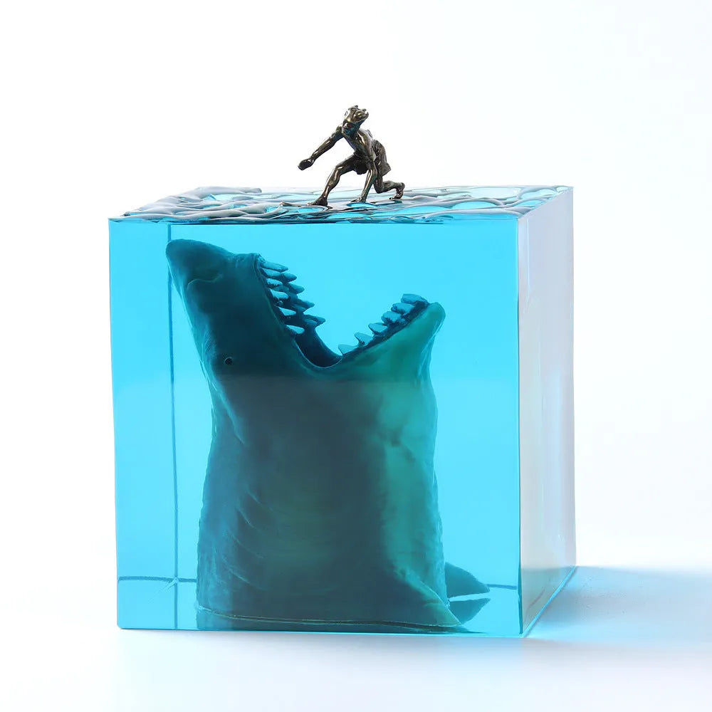 Clear epoxy resin ornament with a detailed shark surfing scene inside, shown next to its integrated lamp holder.