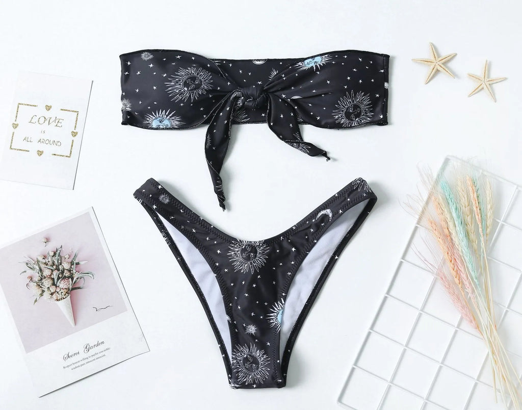 Black one-piece swimsuit with bikini print split tube top and backless design.