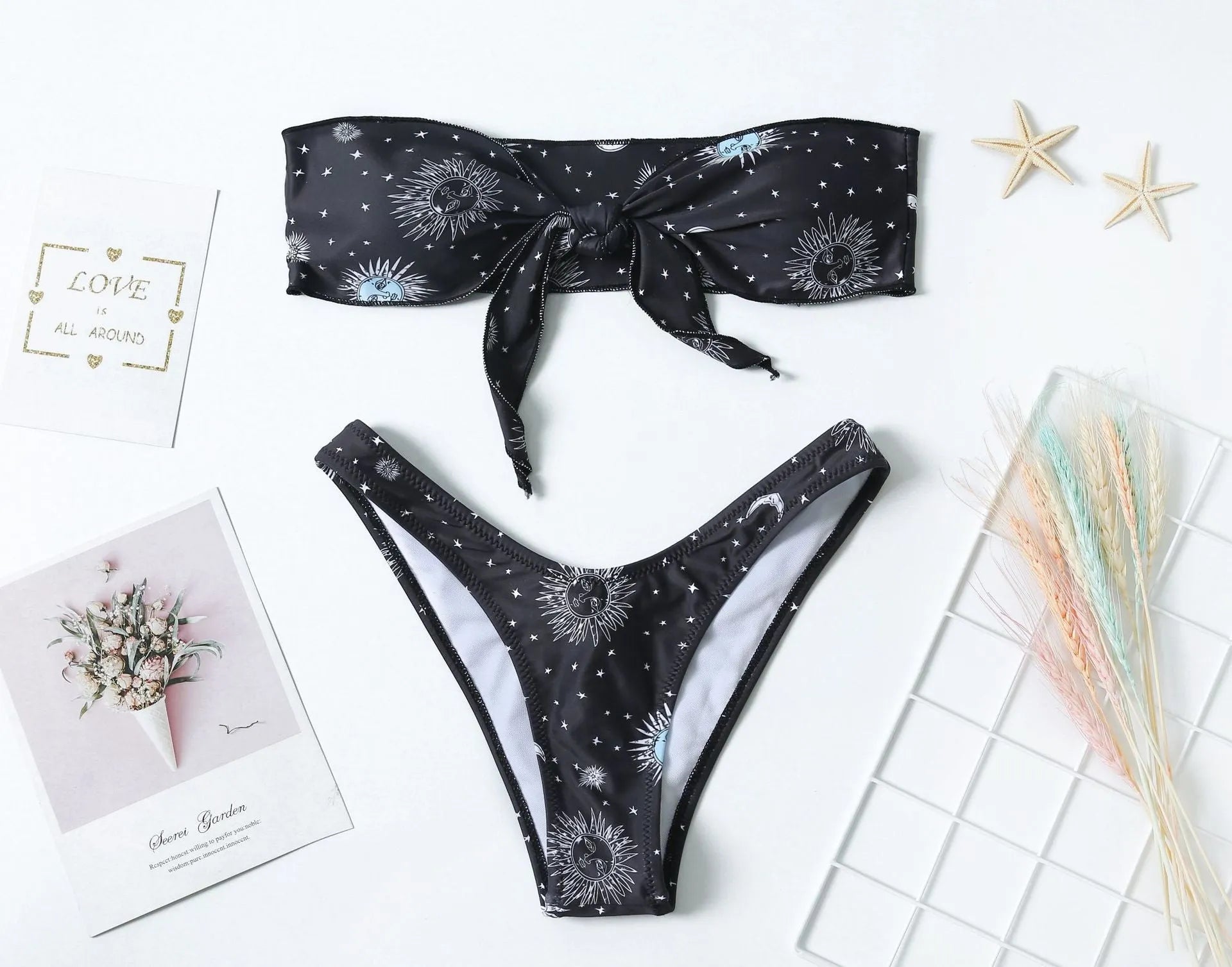 Black one-piece swimsuit with bikini print split tube top and backless design.