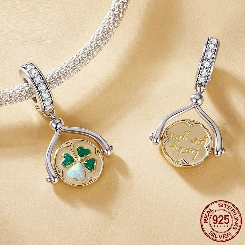 925 sterling silver rotating card pendant with four-leaf clover and wing detail on white background