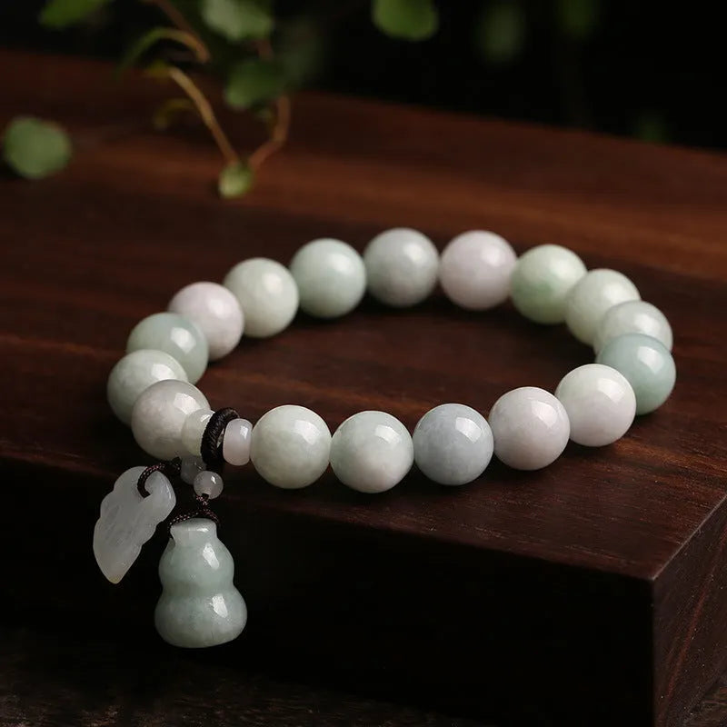 Natural jade hanging bracelet with carved pendant showing geometric design