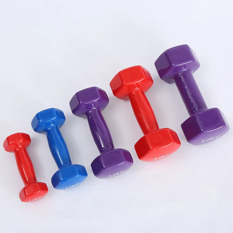 Brightly coloured plastic fitness dumbbells in 0.5kg, 1kg, and 1.5kg weights on a light background