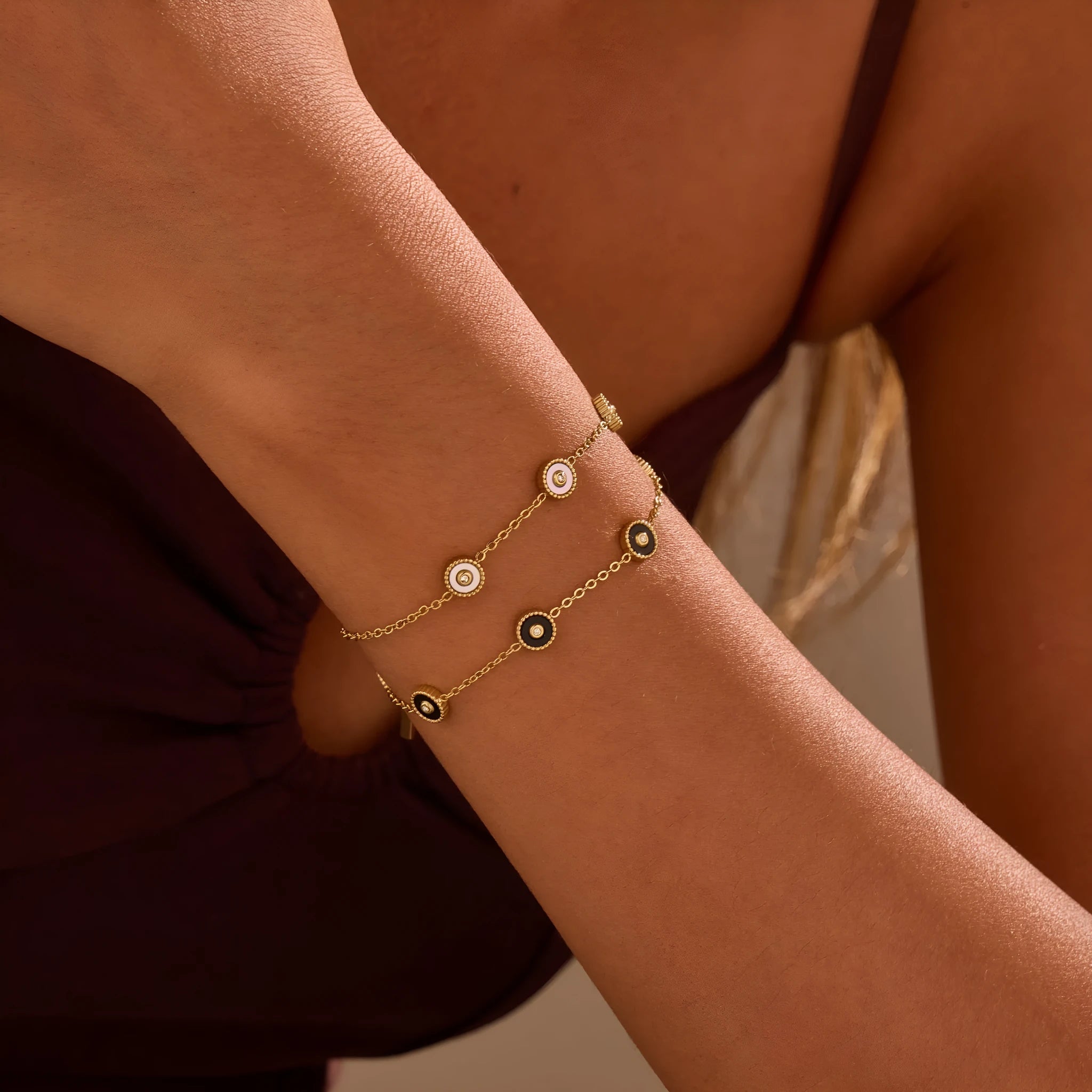 Close-up of a women's geometric fritillary pattern bracelet and necklace set in gold-plated stainless steel.