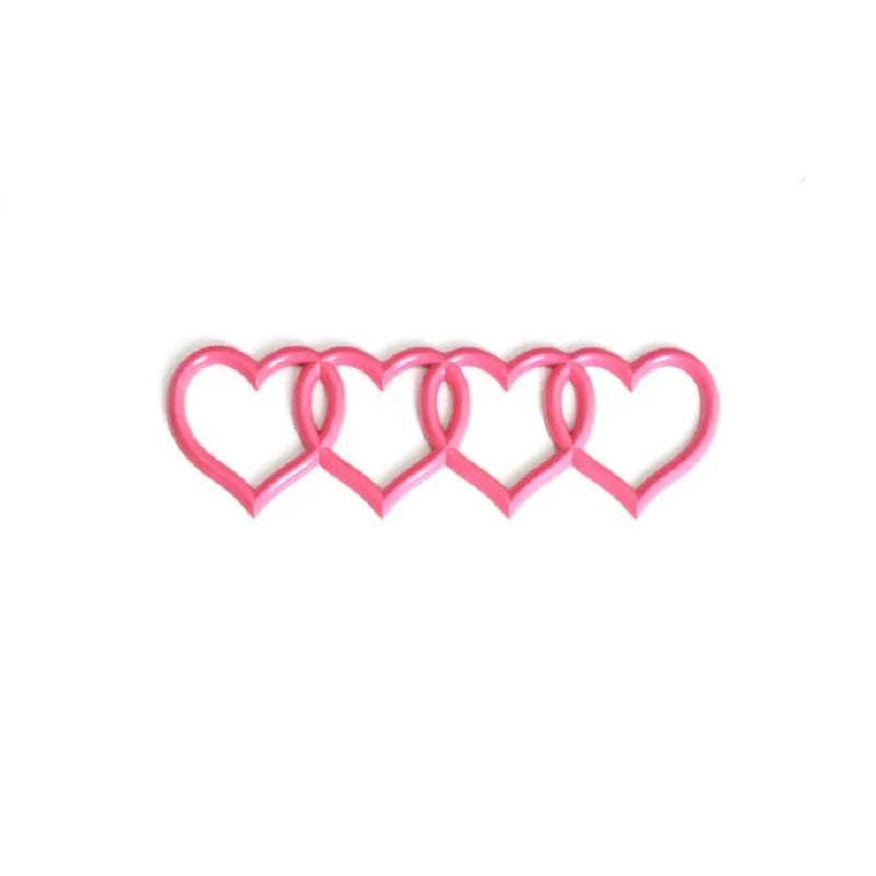 Heart-shaped body sticker with four-ring tail design in electroplated silver colour on a car bumper