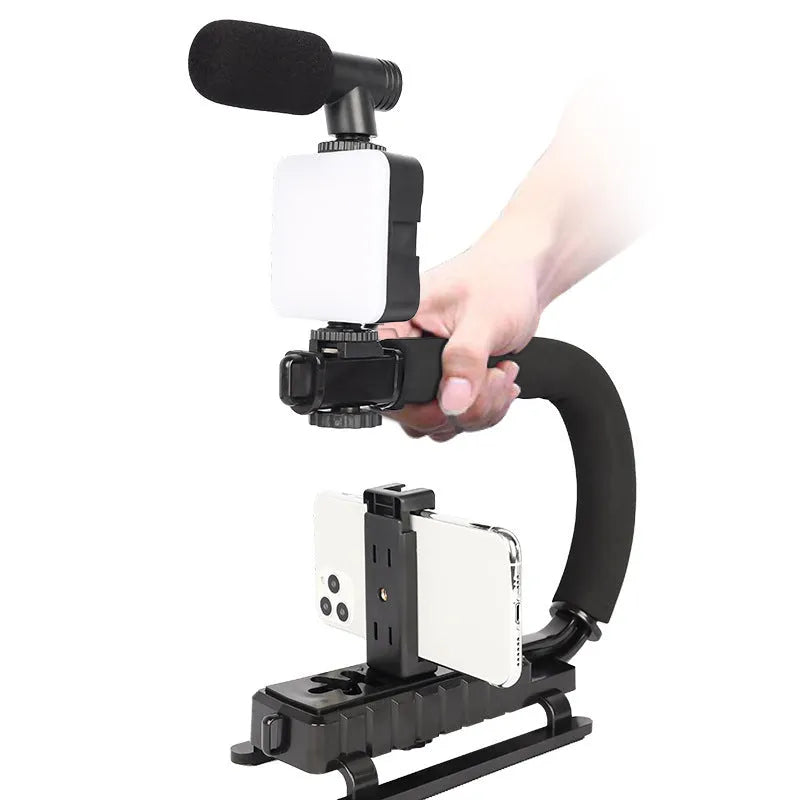 Small square LED camera flash on a mini tripod, showing rotatable head and compact size.