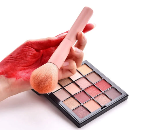 Open case showing 10 pink-handled makeup brushes including loose powder, foundation, flat head, and double-ended brushes.
