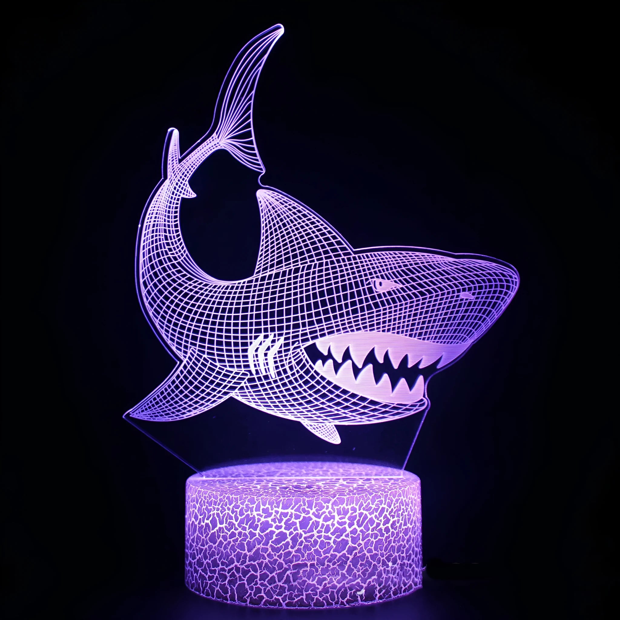 Shark shaped 3D LED table lamp with colourful lighting and remote control on wooden surface