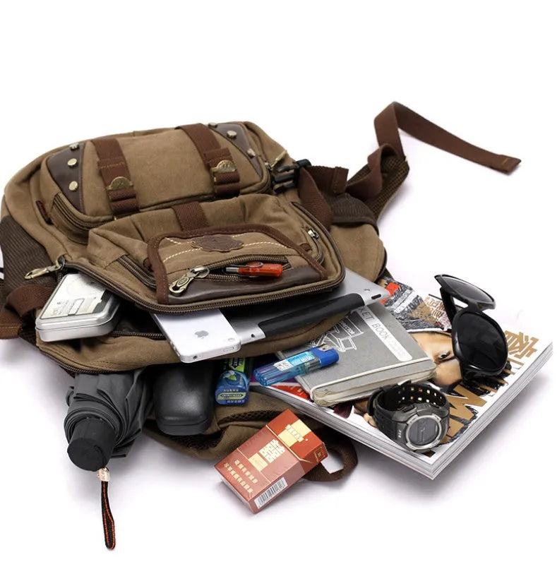 Canvas computer backpack in black with square vertical shape, zip closure, and multiple pockets