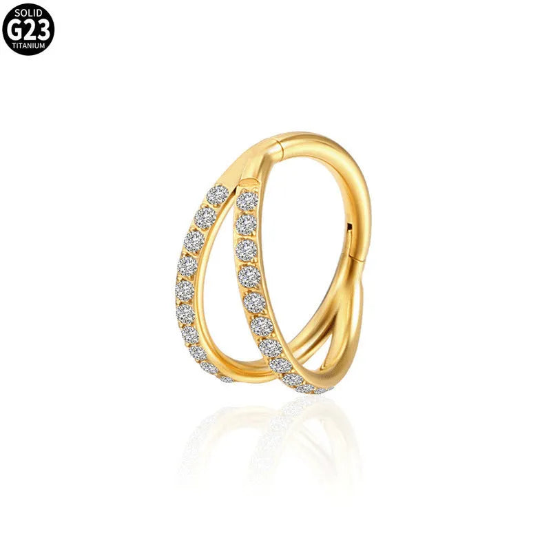 Close-up of a G23 titanium alloy nose or ear ring with a small zircon gemstone, shown in a gold tone finish.