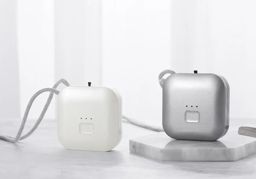 Mini USB portable air purifier necklace in collar design shown in blue, grey, pink and white colours.