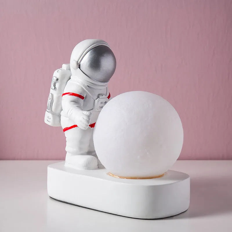 Gold resin astronaut night light on shelf, 14.5cm tall figurine with soft glow