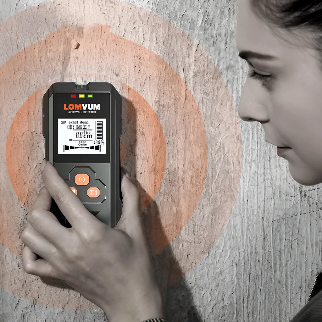 Multifunctional wall detector unit held against a plasterboard wall showing detection depth display