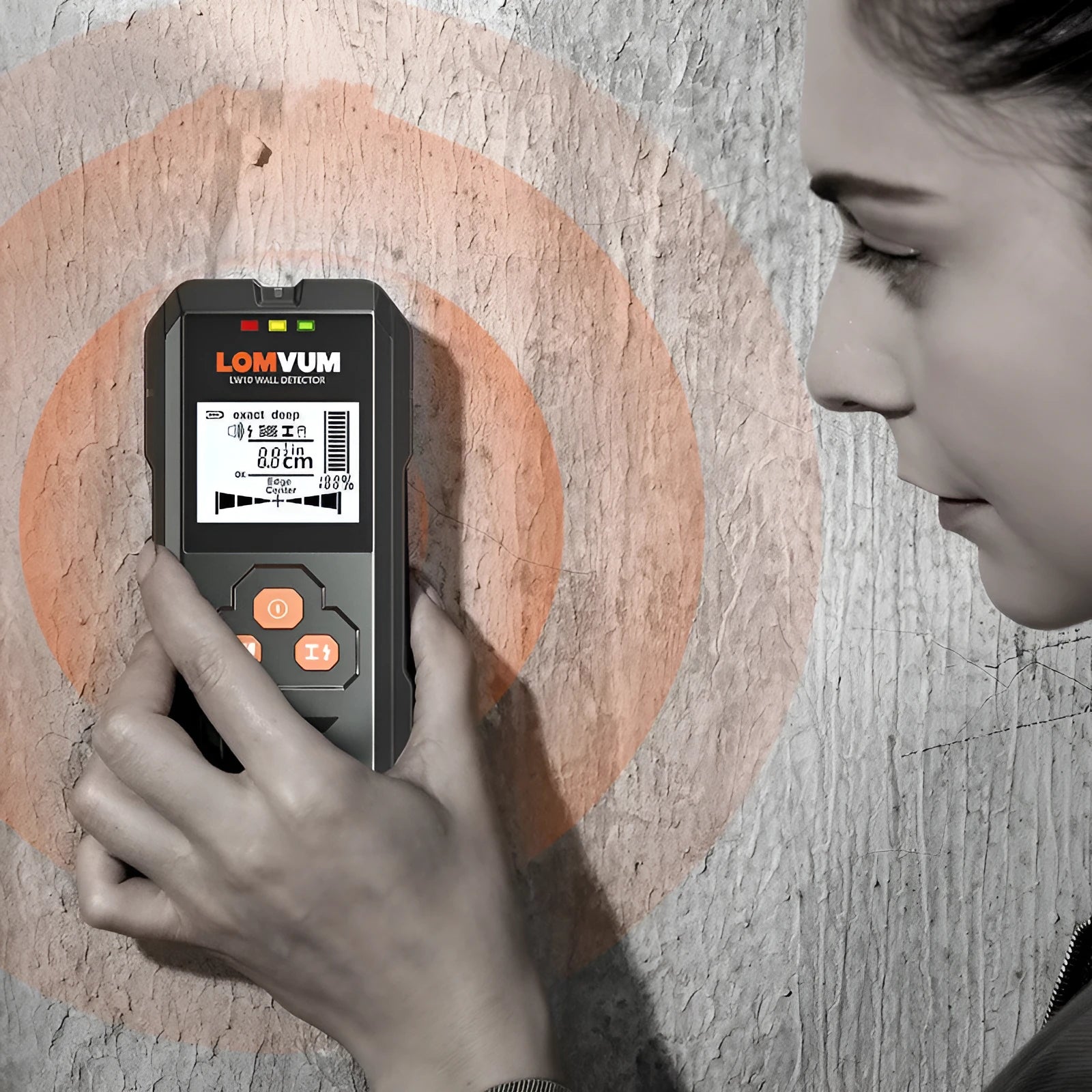 Multifunctional wall detector unit held against a plasterboard wall showing detection depth display