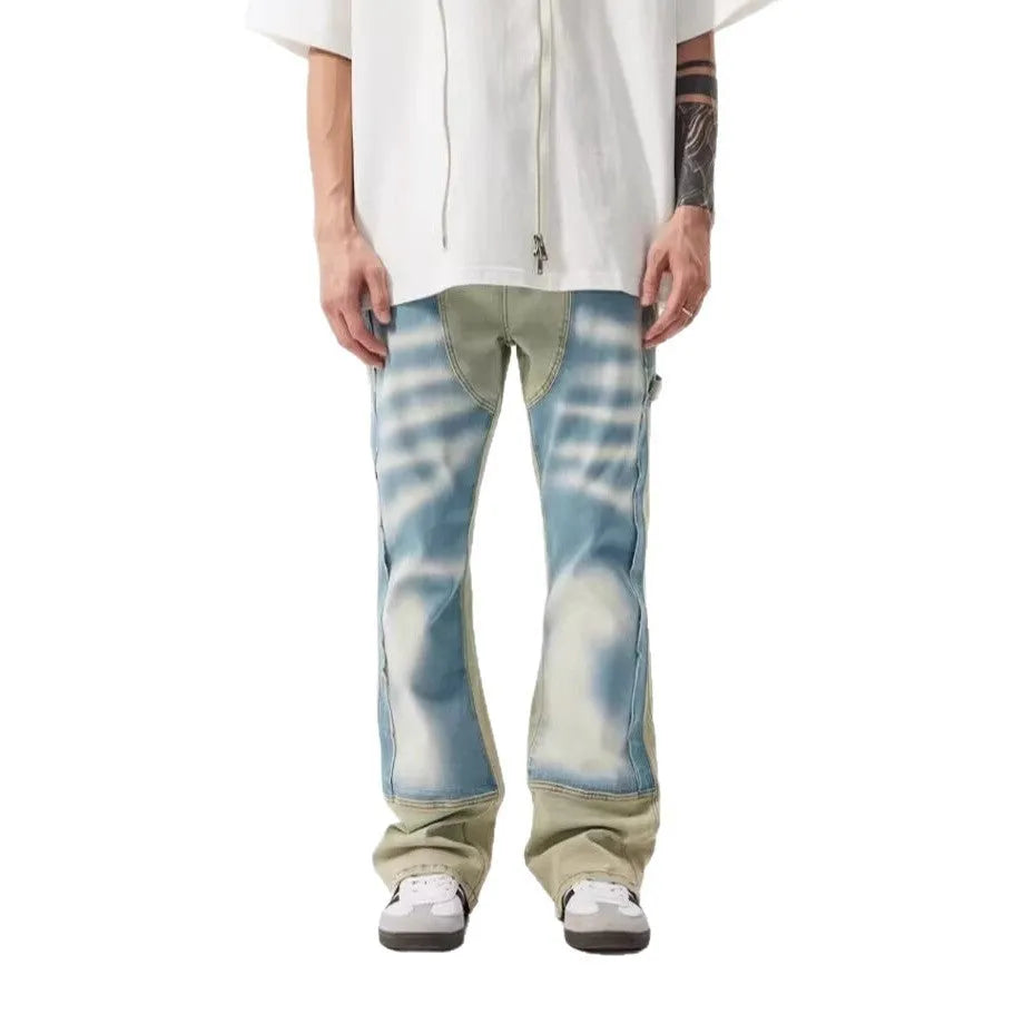 Retro blue and yellow patchwork jeans with splash-ink damaged design on a mid-waist fit.