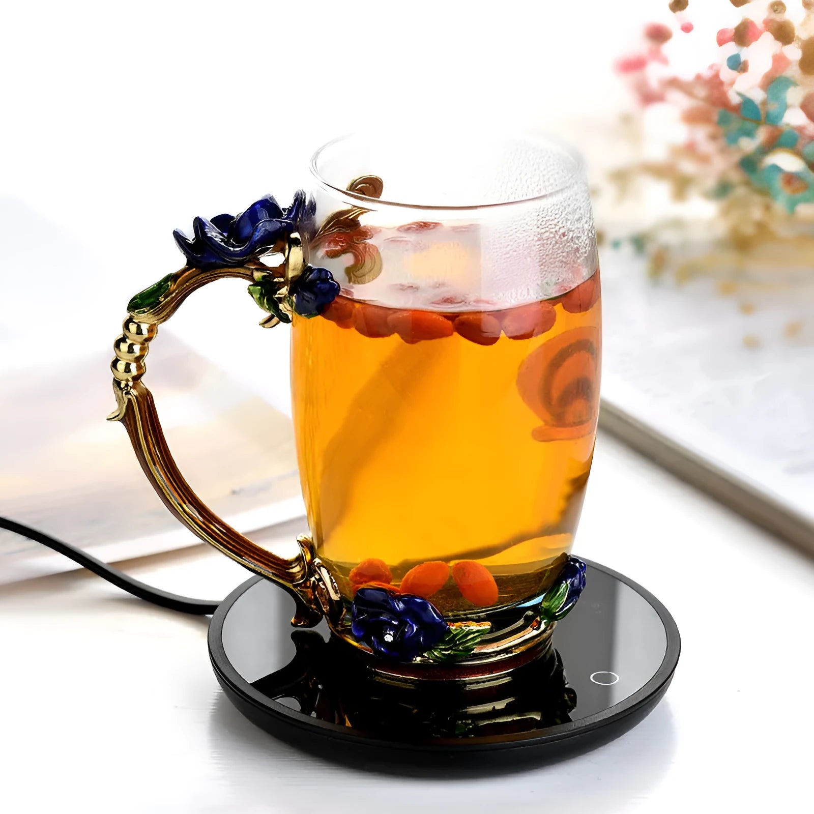 Black dual-temperature coffee mug warmer with low/high switch on a desk.