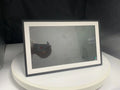 White 15.6-inch smart digital photo frame showing family photographs with adjustable stand