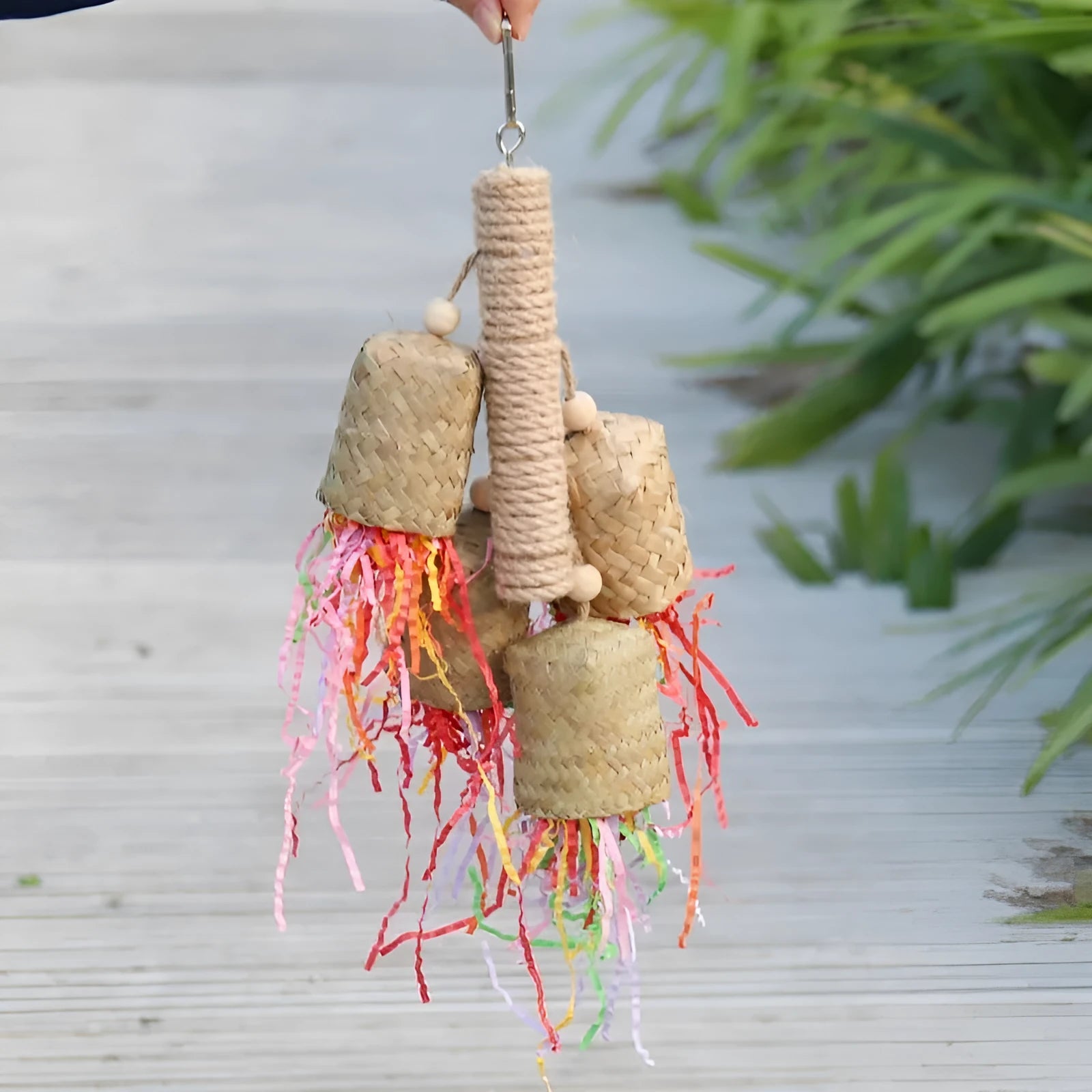 Colourful shredded paper parrot toy with wood and sisal construction measuring 35cm long